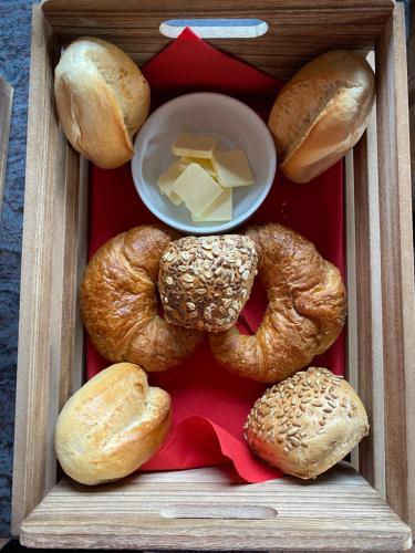 a box of bagels and bread with cheese and butter at Gästehaus Lara in Wimbach
