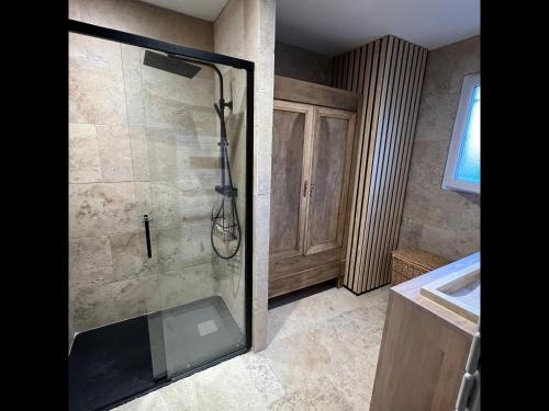 a bathroom with a shower with a glass door at La Granja - Maison avec cheminée, jardin, baby-foot in Formiguères