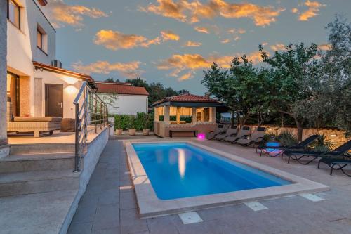 a swimming pool in the backyard of a house at Villa Lelaina near Pula with private Pool and 3 km from the beach in Šegotići