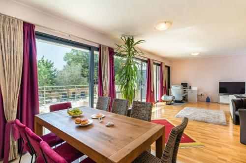 a living room with a wooden table and chairs at Villa Lelaina near Pula with private Pool and 3 km from the beach in Šegotići