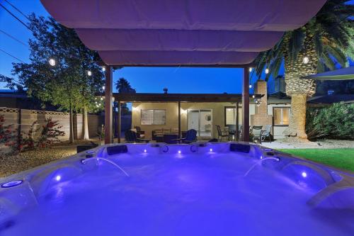 a hot tub in the backyard of a house at night at Beautiful home with spa and golf in Las Vegas