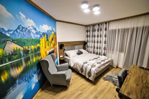 a bedroom with a large painting of a mountain at Willa Nosalowa Dolina in Zakopane