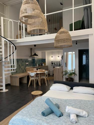 a bedroom with a bed and a living room at Alex- DUPLEX APARTMENT- City in Valencia