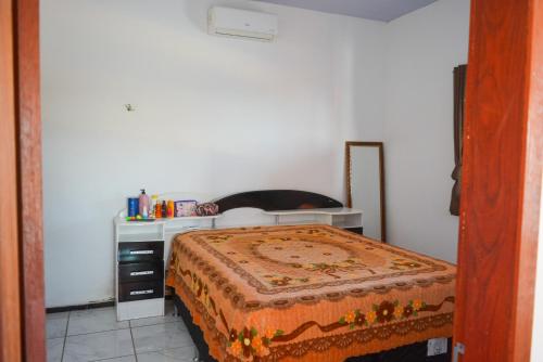 a small bedroom with a bed and a desk at Casa Mirante da Ilha in Arez
