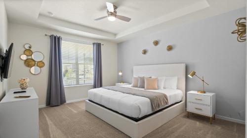 a white bedroom with a bed and a window at Amazing Villas 20 minutes away from Disney! in Kissimmee