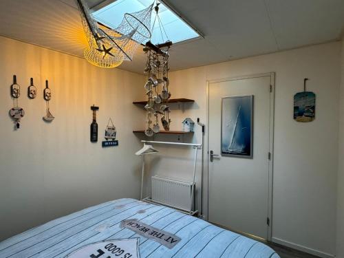 a bedroom with a bed and a window and a door at Coastal Dreaming in Egmond aan Zee