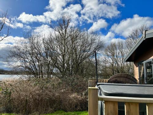 a house with a fence next to a body of water at Coniston View 7 in Warton