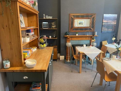 a dining room with a table and a table and chairs at Monico Guest House in Scarborough