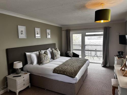 a bedroom with a large bed and a balcony at The Lenchford in Worcester