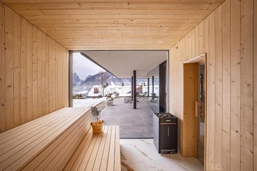 a timber house with a view of the mountains at Golden Hill Apt Enjoy in Dobbiaco