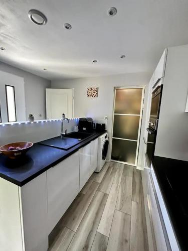 a large kitchen with a sink and a dishwasher at Pavillon de Standing - Parking Privé - Proche CERN/ONU/Genève in Prévessin-Moëns