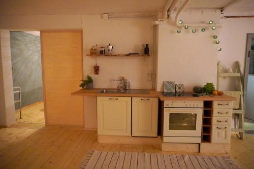 a kitchen with a sink and a stove top oven at Oide Schreinerei in Steingaden