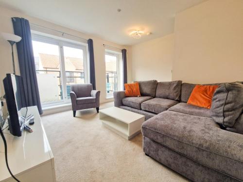 a living room with a couch and a tv at Charming 2BR Townhouse with Games Room in Hull