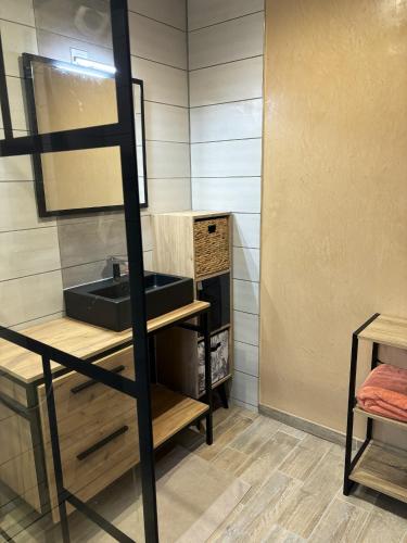 a bathroom with a sink and a mirror at Maison charmante près de Sains avec spa et jardin clos in Sains