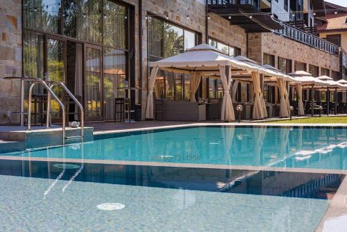 a swimming pool in front of a building at TERRA KOMPLEX D3 - Private apartment - Golf, Skiing & SPA in Razlog