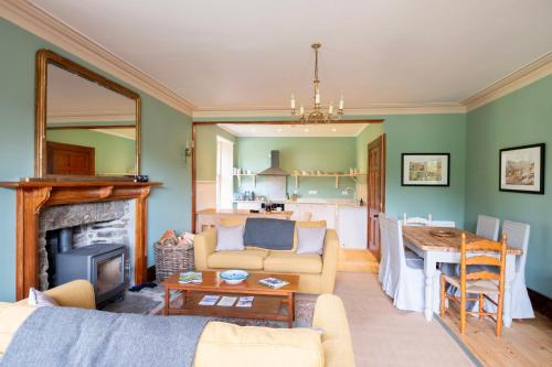 a living room with a couch and a table at Refurbished Highland Lodge in Spectacular Scenery in Pitlochry