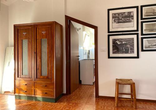 a hallway with a wooden cabinet and a mirror at Casa Dolci Rodolfo 4km from the sea in Montemarciano