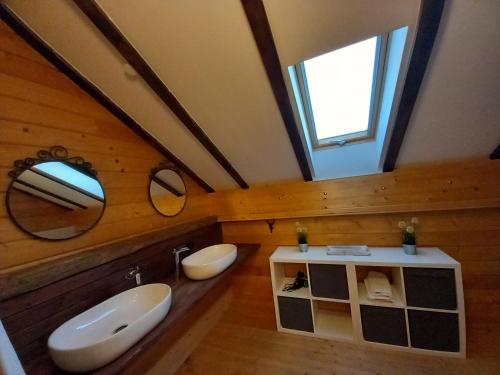 un bagno con due lavandini e due specchi di Gemütliches Holzhaus in Gamlitz! a Gamlitz