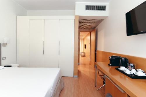 Ένα ή περισσότερα κρεβάτια σε δωμάτιο στο Hotel Excelsior Bari