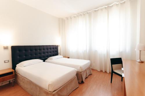 Ένα ή περισσότερα κρεβάτια σε δωμάτιο στο Hotel Excelsior Bari