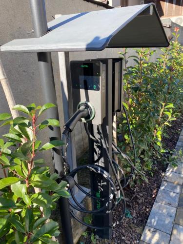 a parking meter with a pay phone on a pole at Ca’ del Riccio Blu in Bra