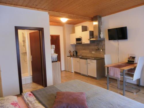 a living room with a kitchen and a dining room at Apartment zum Wasserfall in Krakaudorf