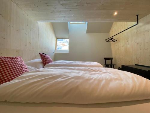 a bedroom with a large white bed in a room at Hideaway Planneralm operated by JUFA Hotels in Planneralm