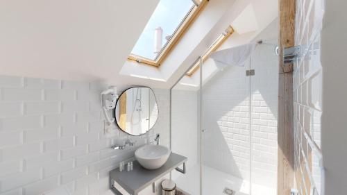 a bathroom with a sink and a mirror at Garden Suites Residence by TKC in Prague
