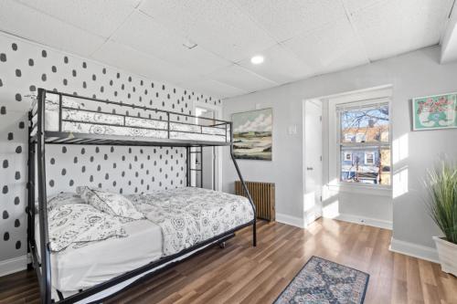 a bedroom with a bunk bed and a wall with polka dots at Whimsical three in Bayonne