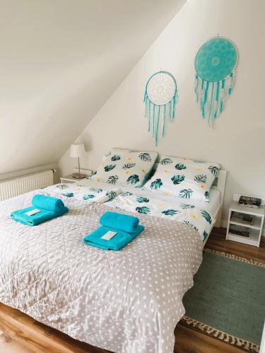 a bedroom with a bed with blue pillows on it at Roztoczańskie Zacisze in Kaczórki