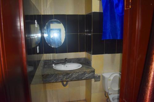 a bathroom with a sink and a toilet at DAVIS HOTEL AND SUITES in Port Harcourt