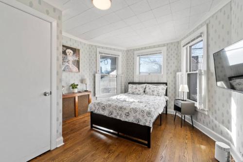 a bedroom with a bed and a television in it at The Whimsical Estate in Bayonne