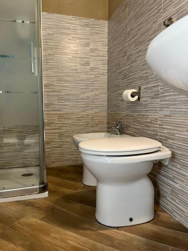 a bathroom with a toilet and a sink and a shower at Gloria Hostel Milano in Milan