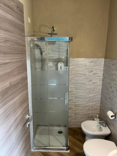 a bathroom with a shower and a toilet and a sink at Gloria Hostel Milano in Milan