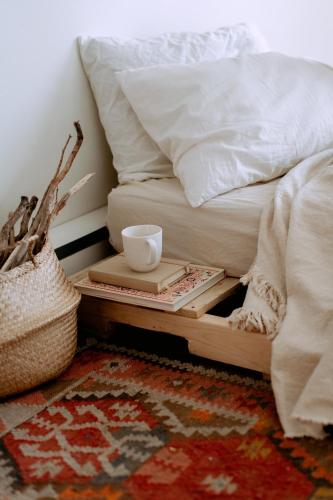 a bed with a tray with a coffee cup on it at Royal Logis Patagon in Mont-Louis