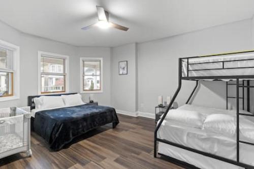 a bedroom with two bunk beds and a ceiling fan at Modern Dream Loft in Bayonne