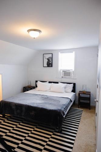 a bedroom with a large bed and a window at Rainforest Retreat 20m to NYC Parking Sleeps 25 in Bayonne