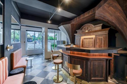 a bar in a restaurant with a counter and stools at Sunset Mu Style Inn in Xiaoliuqiu