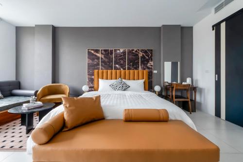 a bedroom with a large bed and a couch at Sunset Mu Style Inn in Xiaoliuqiu
