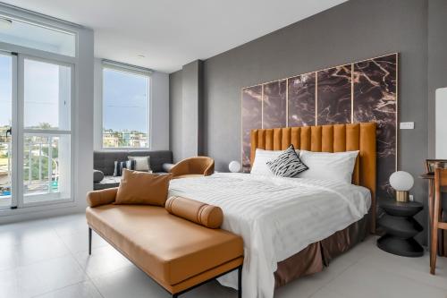 a bedroom with a large bed and a chair at Sunset Mu Style Inn in Xiaoliuqiu