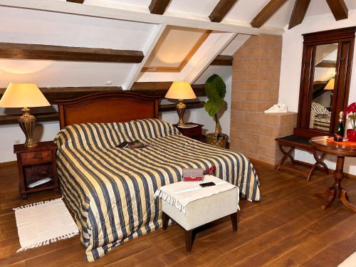 a bedroom with a bed and a table and a mirror at Villa Anica Dubrovnik - luxurious with a sea view in Dubrovnik