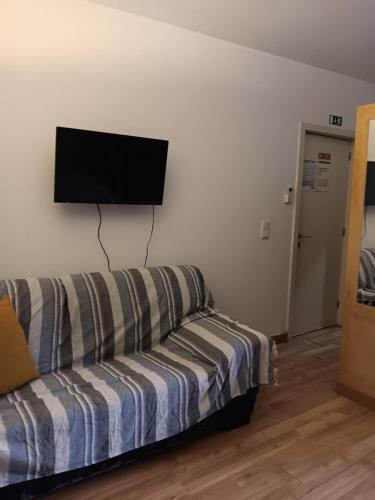 a living room with a couch and a flat screen tv at Porto Centro Station in Porto
