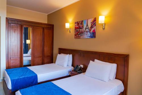 Ένα ή περισσότερα κρεβάτια σε δωμάτιο στο Blumar El Dome Hotel