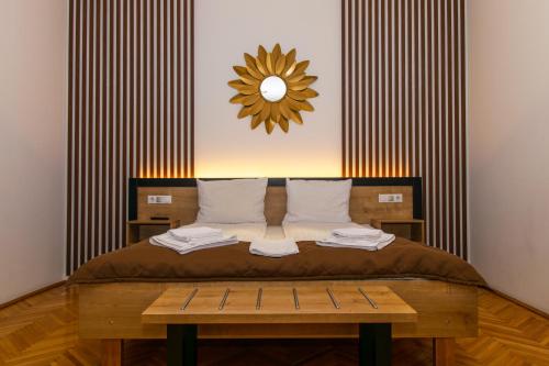 a bedroom with a bed with a mirror on the wall at 4Rooms Central Sibiu in Sibiu