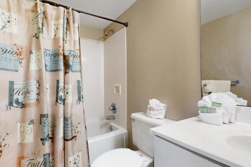a bathroom with a toilet and a shower curtain at The Resorts Of Pelican Beach 1413 Destin (Condo) in Destin