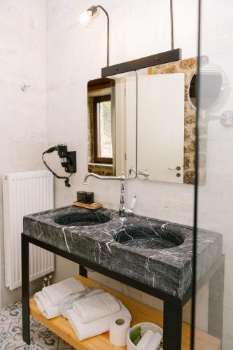 a bathroom with a marble sink and a mirror at Anotopos in Ano Trikala