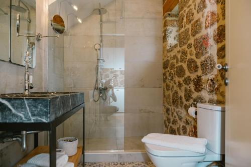a bathroom with a sink and a toilet and a shower at Anotopos in Ano Trikala