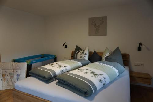 a bed with pillows on top of it at Apartments Edinger in Söll