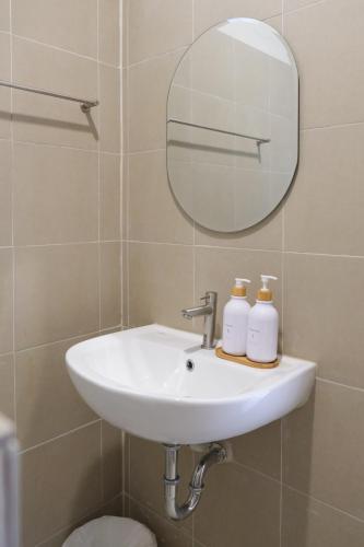 a white sink in a bathroom with a mirror at Nymph Hideout in Koh Phangan