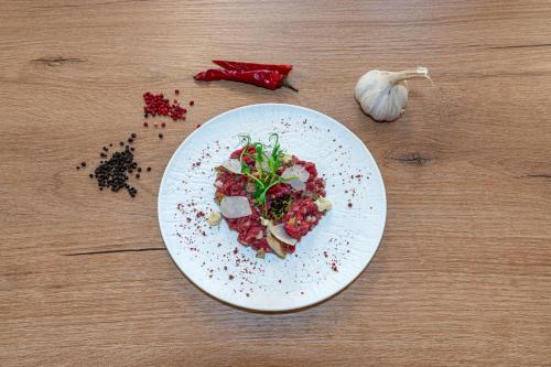 a plate of food on a wooden table at Aparthotel Diamond SPA Aqua in Białka Tatrzanska